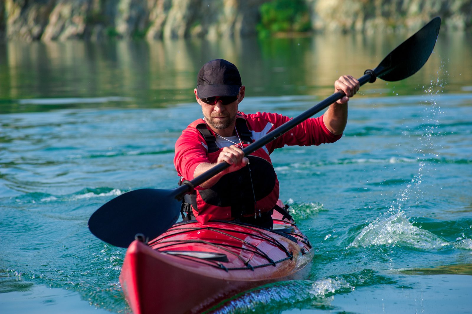 man kayaking in beautiful scenery - paddle pursuits